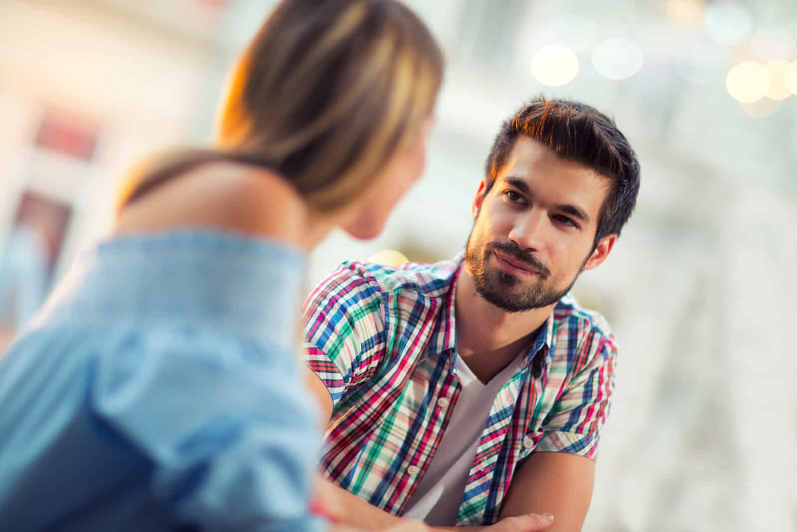 a man and a woman stand and talk