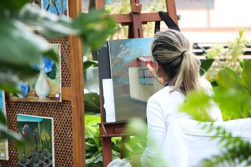 adult woman artist painting on canvass
