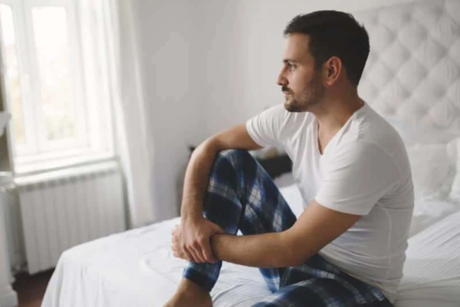 an imaginary man sitting on the bed