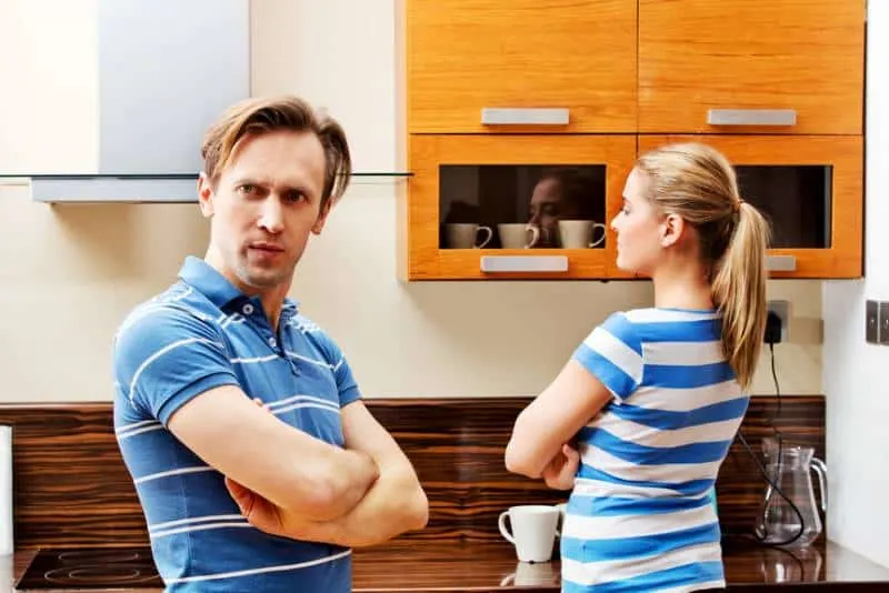 angry couple at kitchen with crossed arms