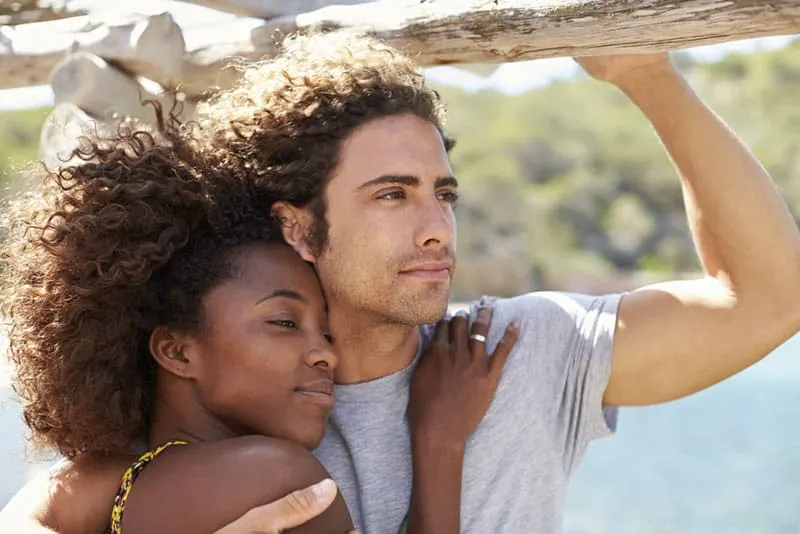 black woman in hug with white man