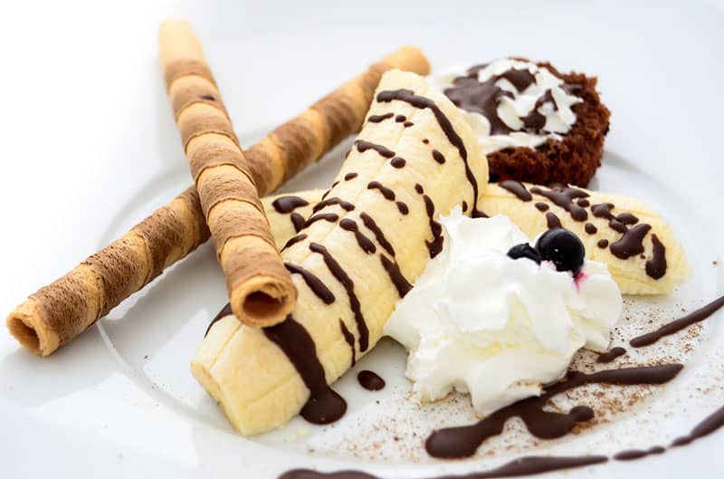 brown-cake and ice cream-on-white-ceramic-plate