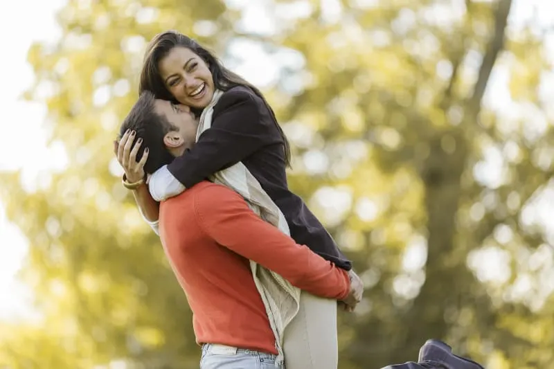 cheerful couple in park in love