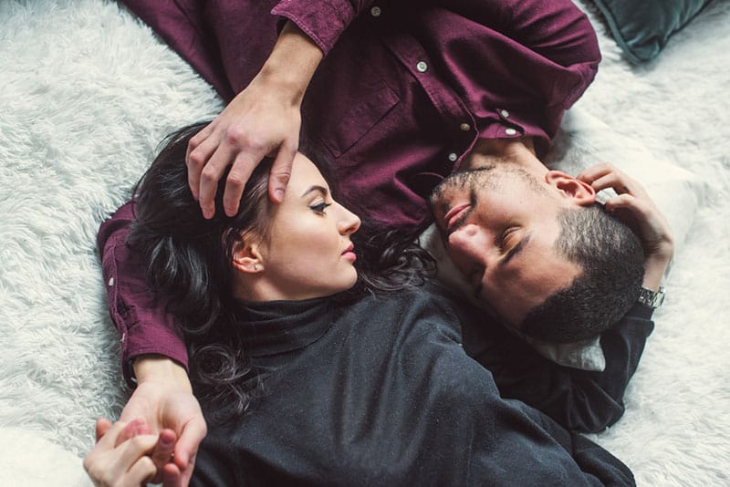 couple cuddling on bed