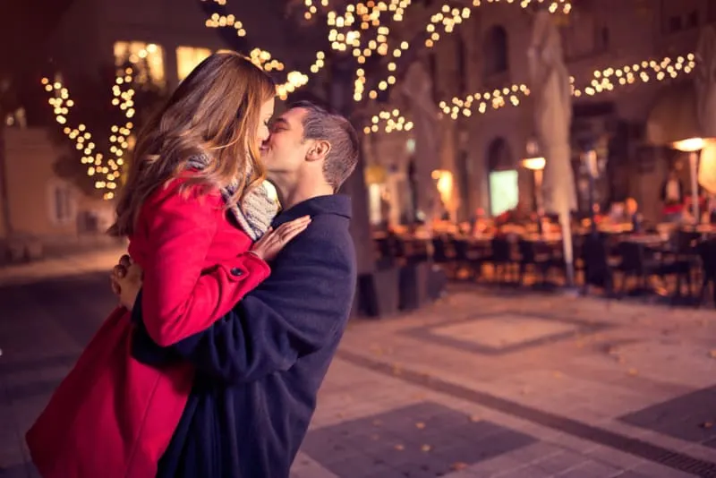 couple kissing in the middle of the town