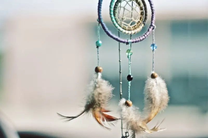 multicolored beaded dream catcher with feathers