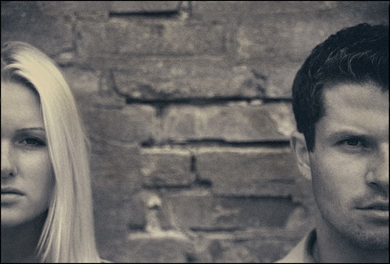 focused photo of man and woman's face in grayscale
