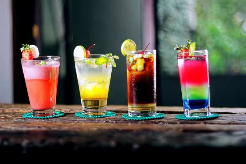 Four glasses with colorfull cocktails on a bar