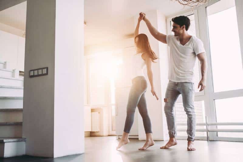 happy couple dancing at home