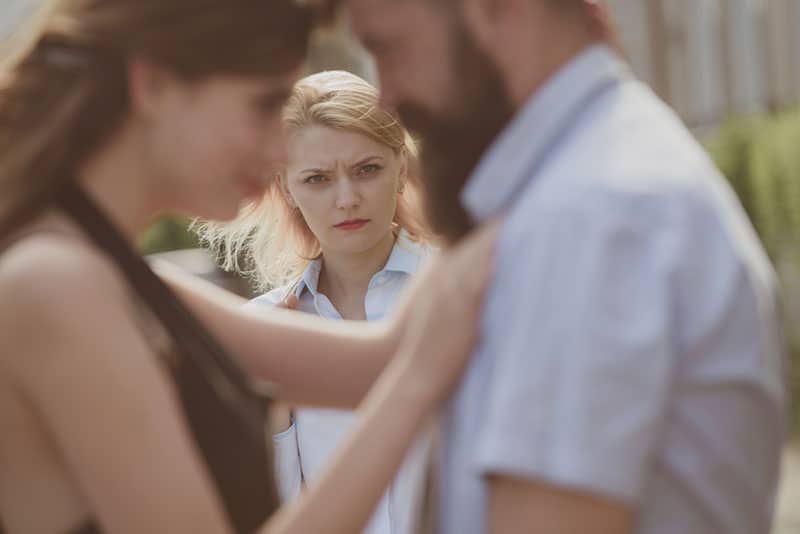 jealous wife looking at couple