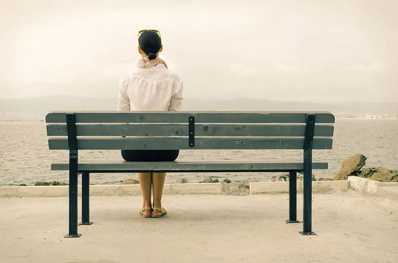 lonely woman sitting on bench