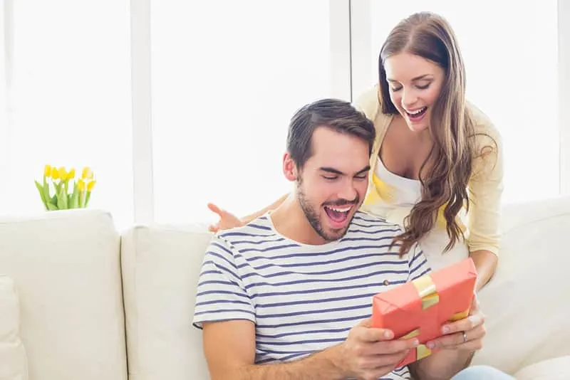 man thrilled by the gift from his girlfriend