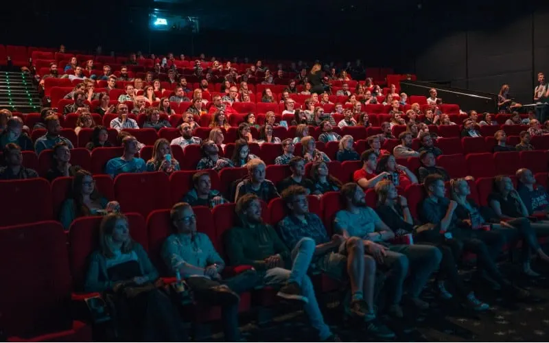 People in cinema room watching movie