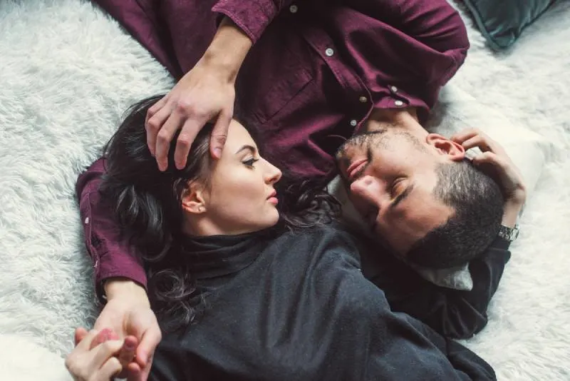 romantic couple lying on floor at home