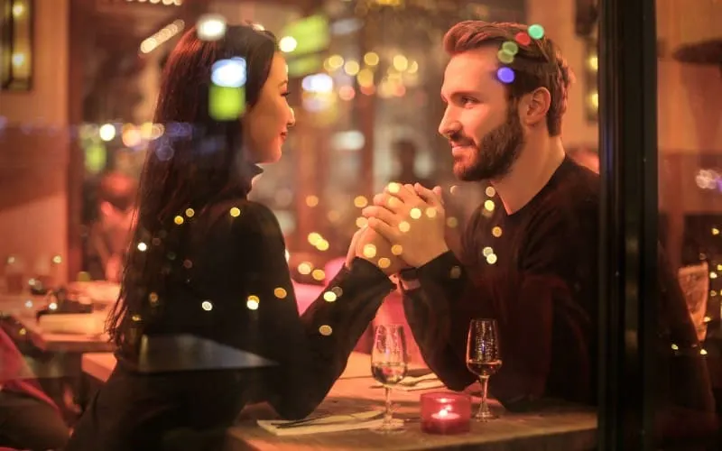 romantic couple sitting at restaurant