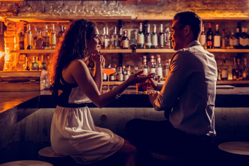 romantic couple talking at bar