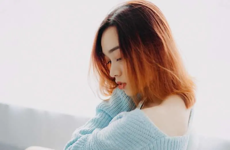 Sad asian girl with red hair