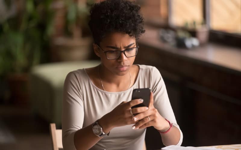 sad woman holding cellphone