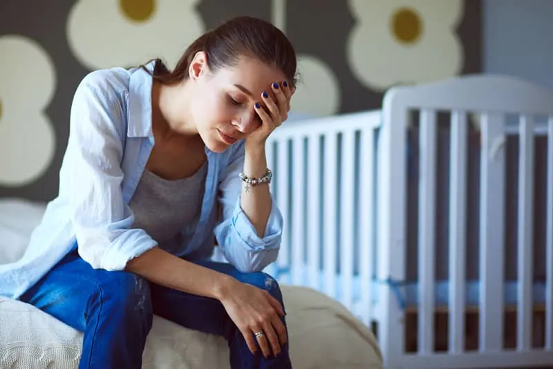sad young woman in bedroom