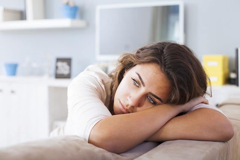 sad young woman on couch