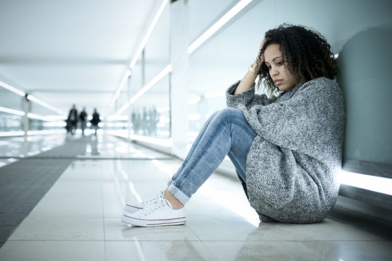 sad girl seated on the floor