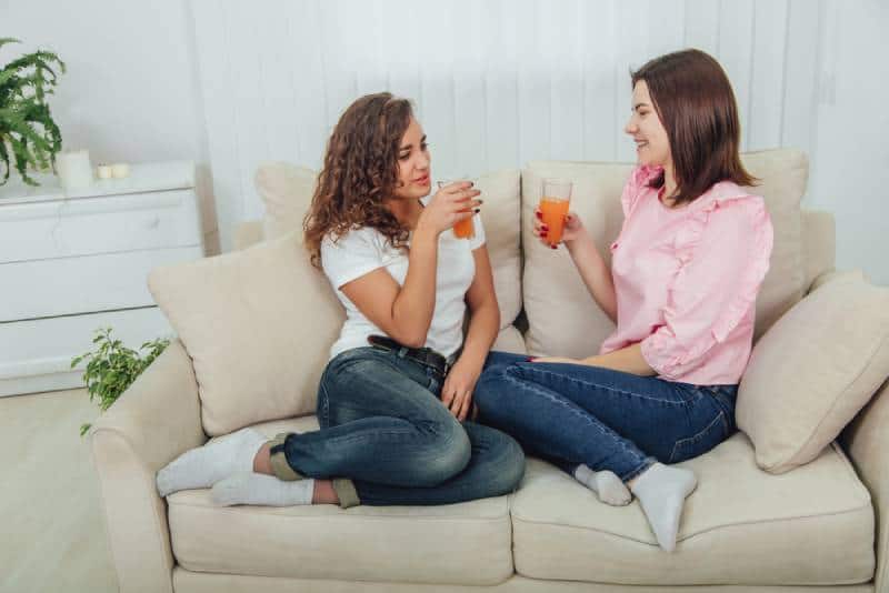 two female friends talking in living room