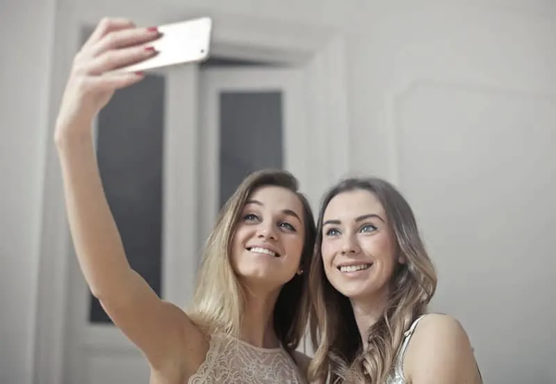 two women on selfie with a cellphone camera