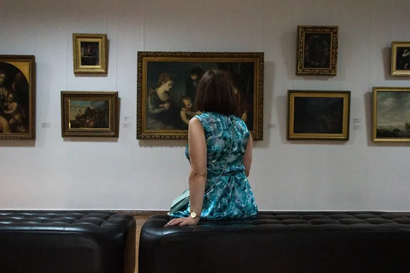 Woman sitting down inside art museum