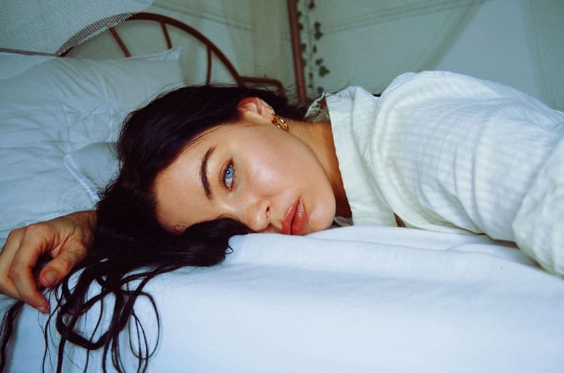 close up photo of a woman lying on bed