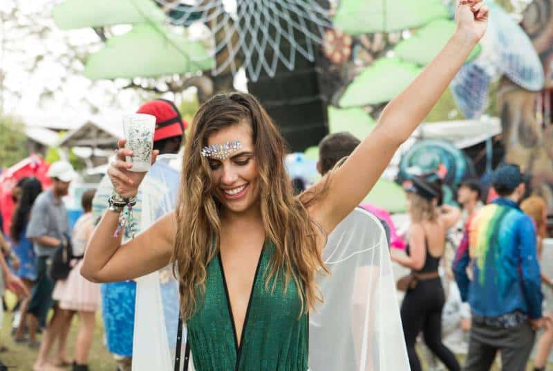 woman raising her hand on music festival