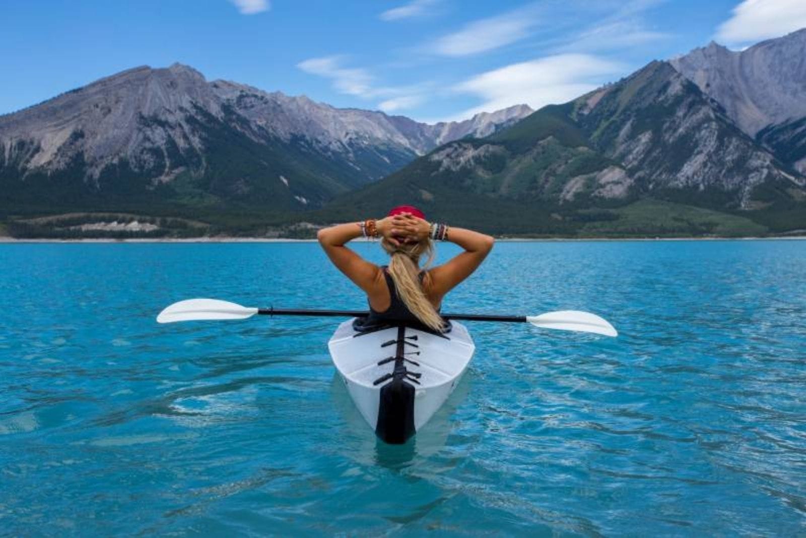 mujer montando en kayak en medio del mar