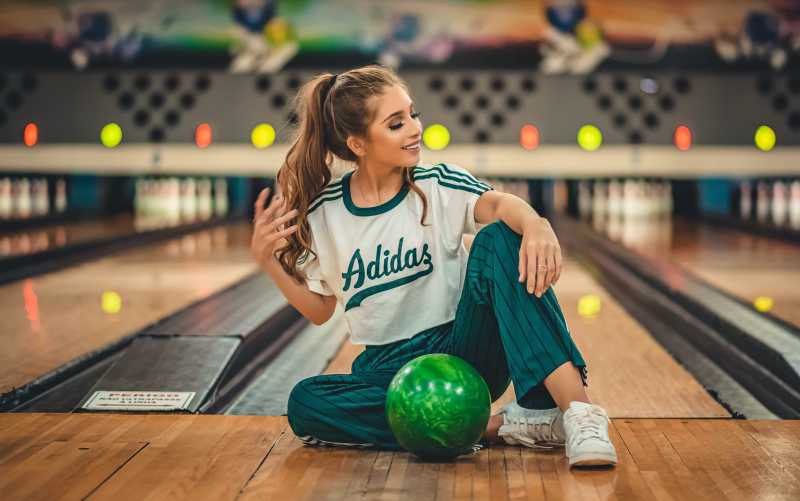 Woman sitting in a bowling alley