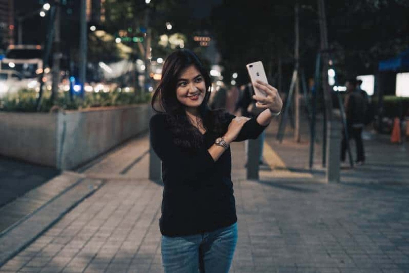 woman taking selfie on street
