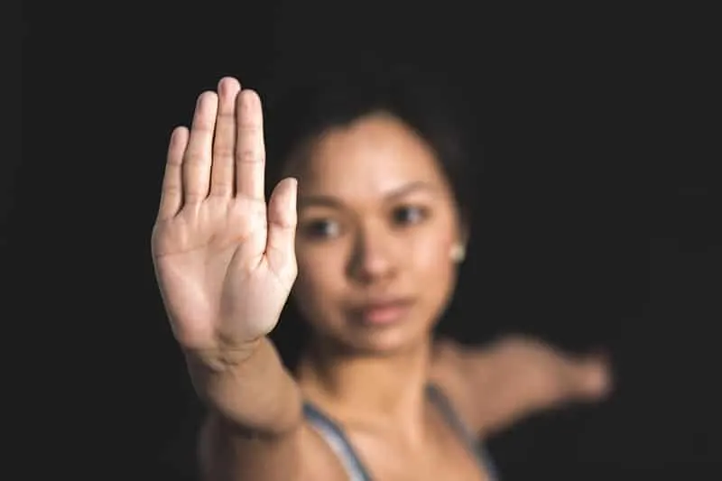 woman with stop sign focused on the right hand palm