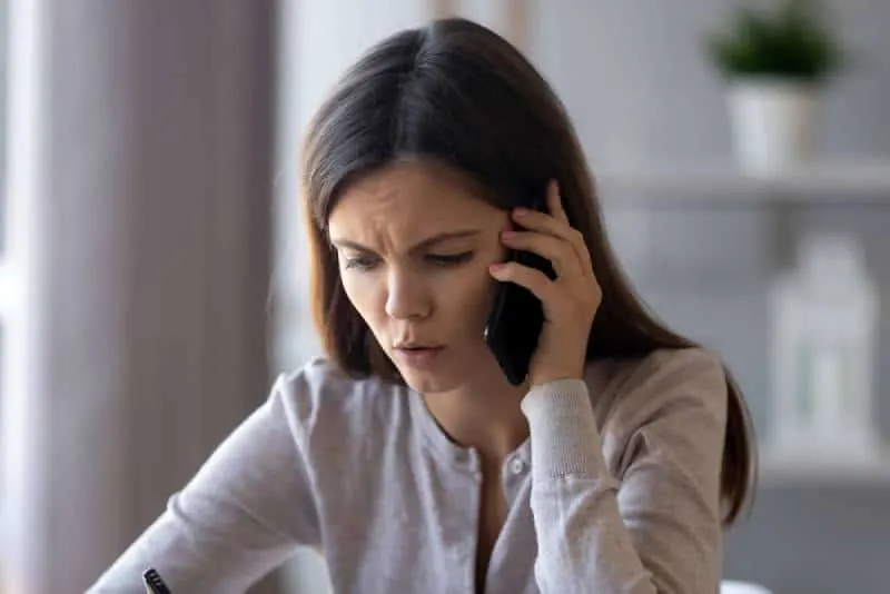 worried woman talking on the phone