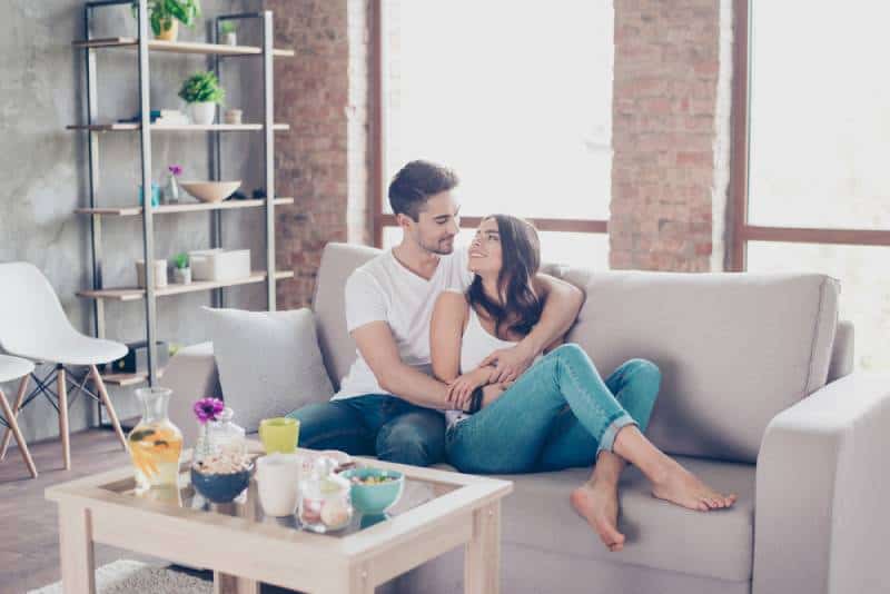 young couple cuddling at home