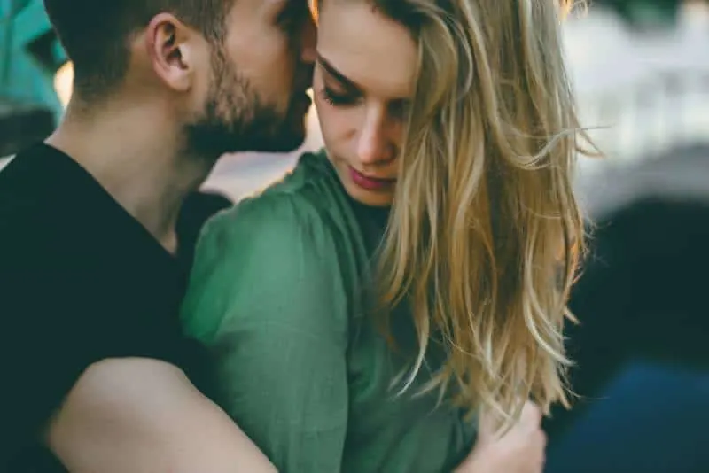 young couple hugging on sunset light