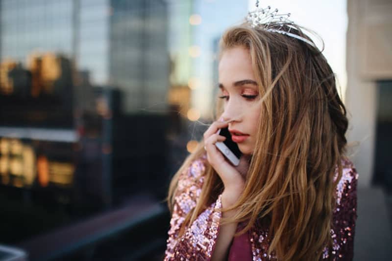 young girl talking on phone outside