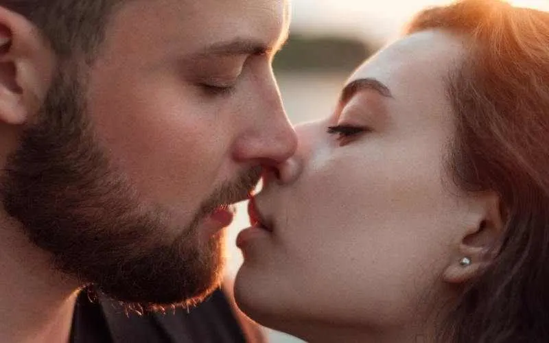 Close up of young man kissing young woman