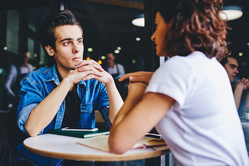 young man listening woman talking