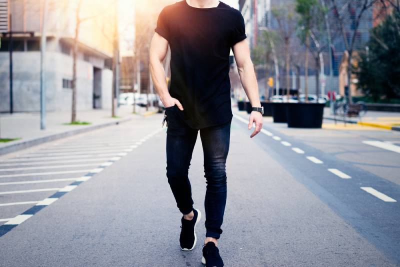 young muscular man walking on the streets