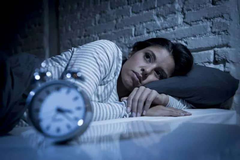 young woman in bedroom late at night