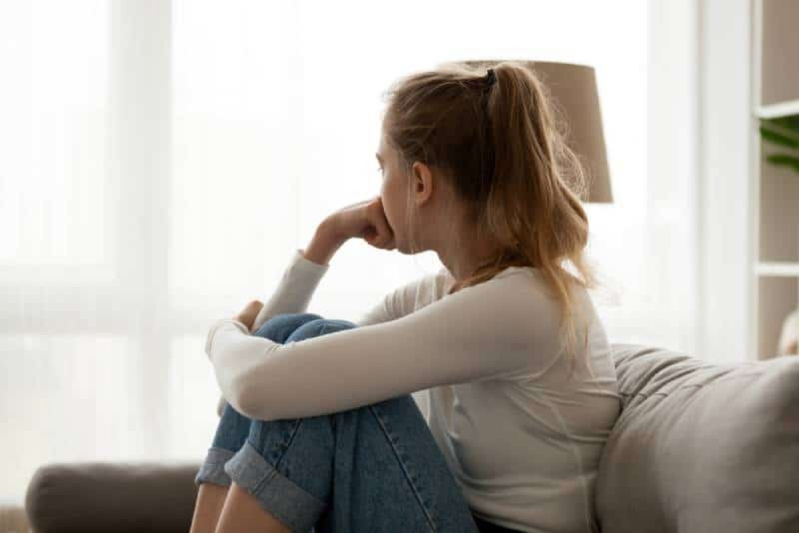 young woman look thoughtful and looking outside