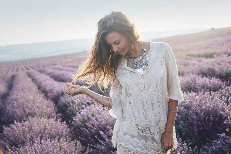 young woman standing in lavender field