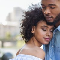 couple standing with closed eyes