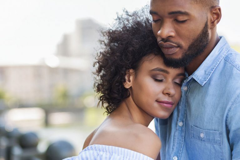 couple standing with closed eyes