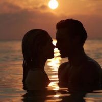 couple in the sea at sunset