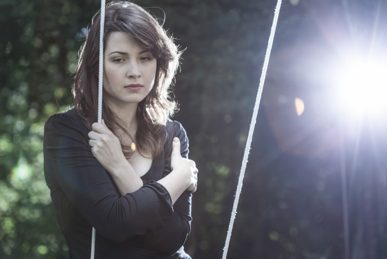 a woman sitting on a swing