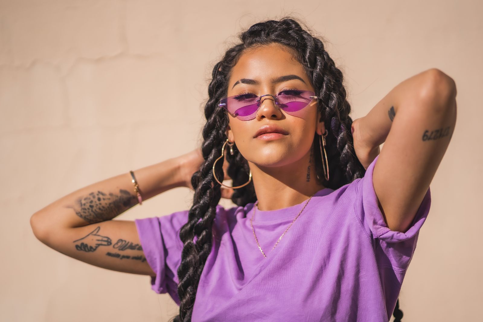 girl in a a pink shirt with tattoos on hand