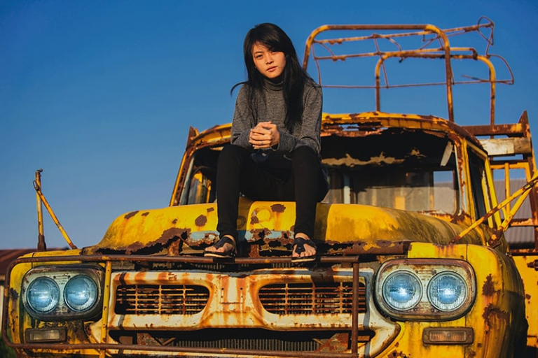 woman on top of vehicle